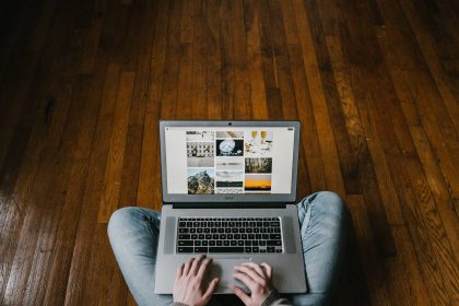 person_sitting_on_floor_using_laptop