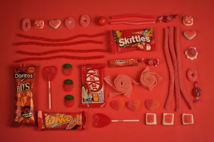 red candy with skittles trident and kitkat wrappers