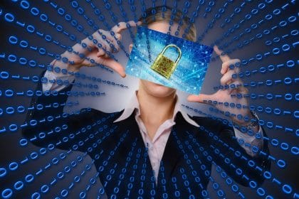 woman holding a photo of a lock on a computer screen