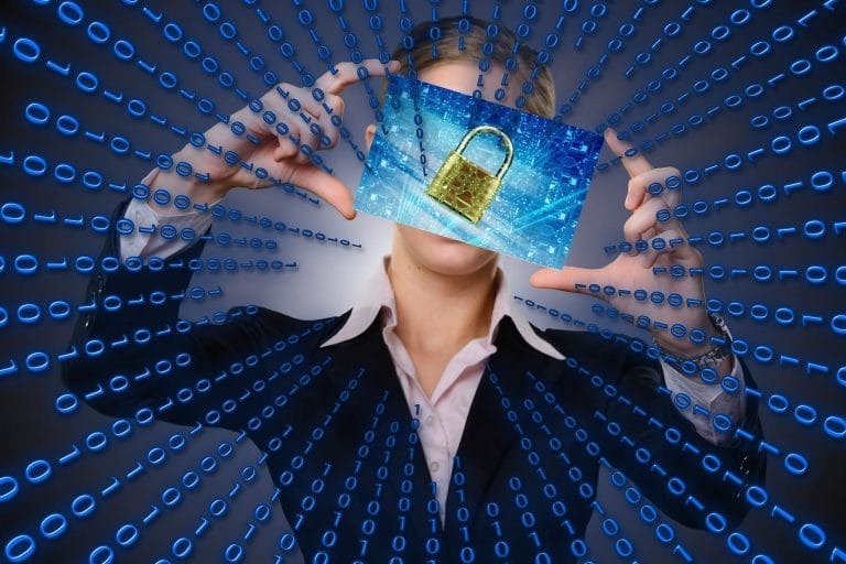 woman holding a photo of a lock on a computer screen