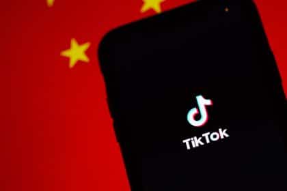 red background with black phone and tiktok logo on the phone